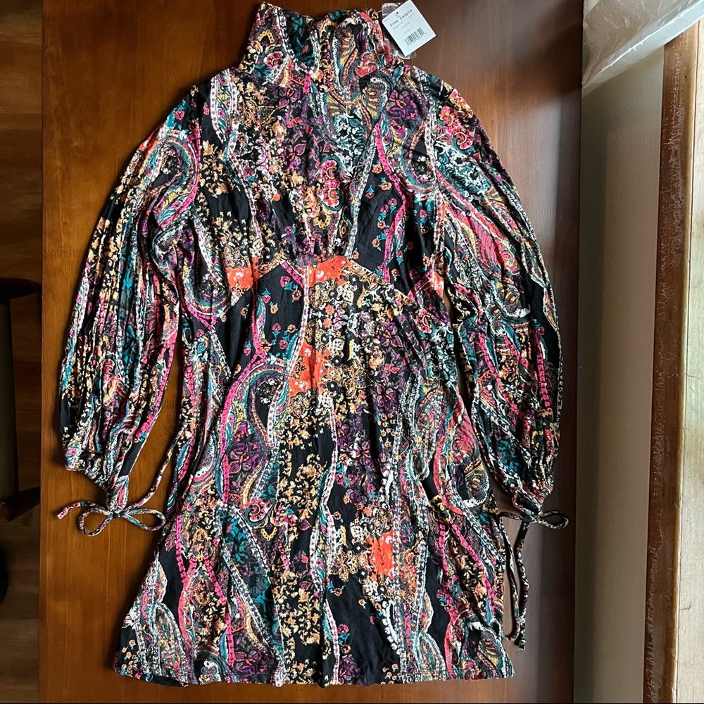 NWT Free People mini dress! Size L. Very fitted. Turtle neck. Keyhole back.